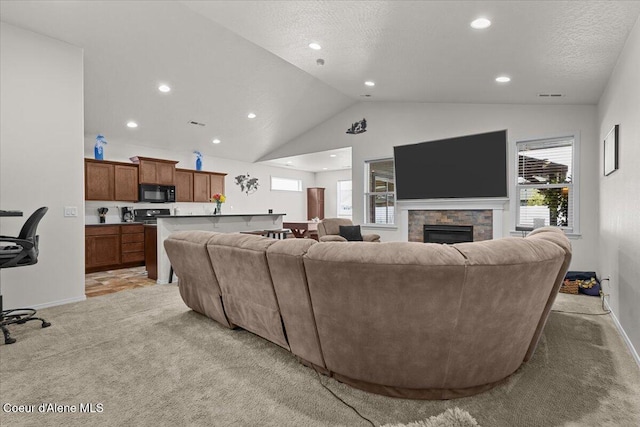 living area with recessed lighting, vaulted ceiling, a healthy amount of sunlight, and light carpet