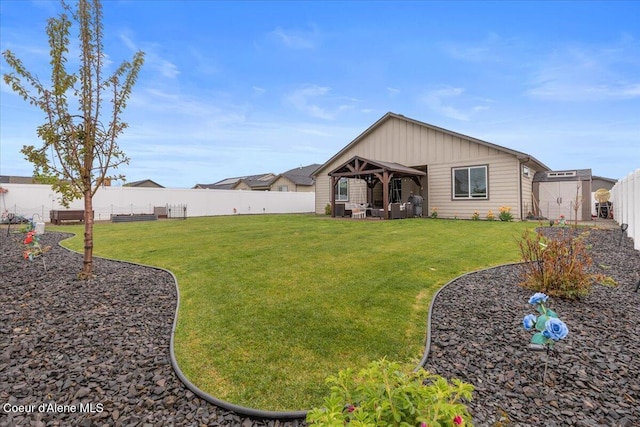 view of yard featuring a storage shed, an outbuilding, and a fenced backyard