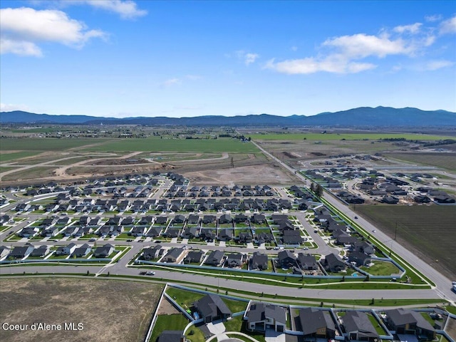 drone / aerial view featuring a residential view and a mountain view