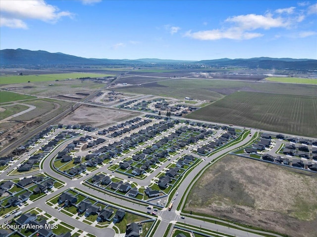 drone / aerial view featuring a mountain view and a rural view