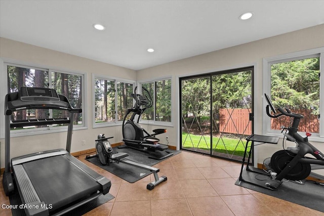 workout area featuring recessed lighting, tile patterned floors, and a healthy amount of sunlight