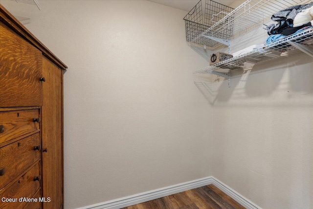 walk in closet featuring dark wood-style flooring