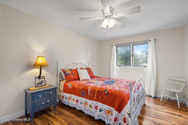 bedroom with baseboards, a ceiling fan, and wood finished floors