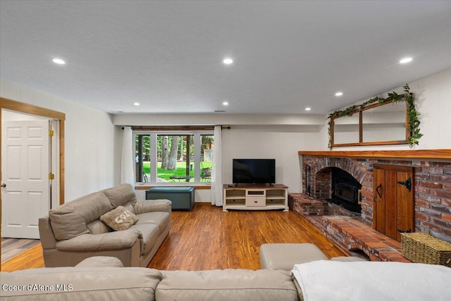living area with recessed lighting and wood finished floors