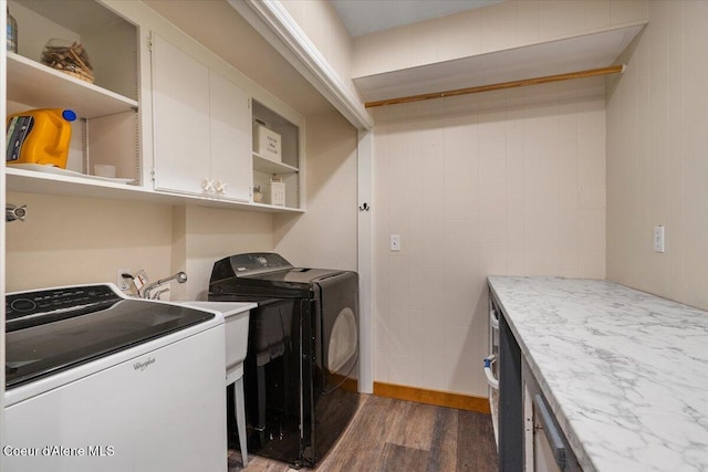 laundry room featuring dark wood-type flooring, cabinet space, and washer and dryer