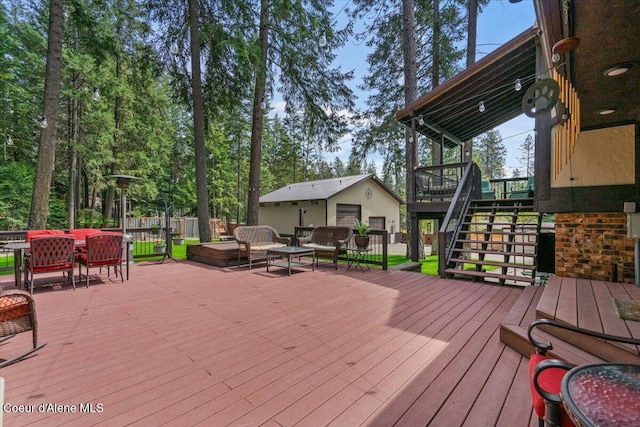 wooden deck with stairway, fence, outdoor lounge area, and outdoor dining area