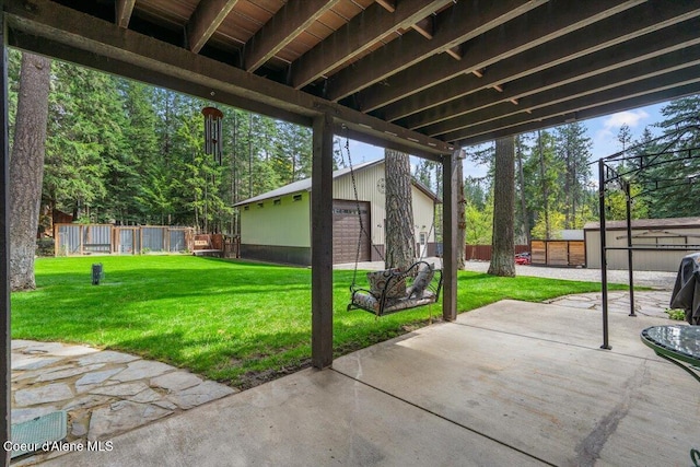 view of patio / terrace with fence and an outbuilding