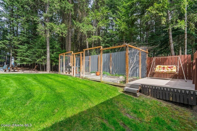 view of yard with fence and a wooden deck