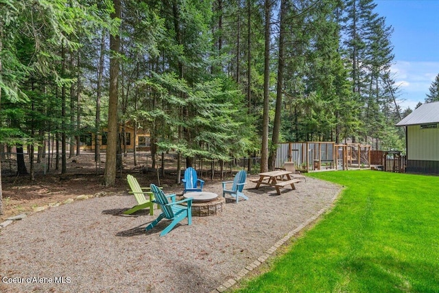 view of yard with fence and a fire pit