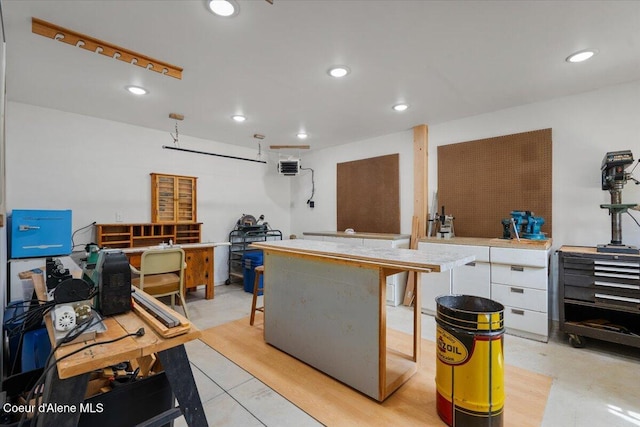 interior space with a breakfast bar area, recessed lighting, and light countertops