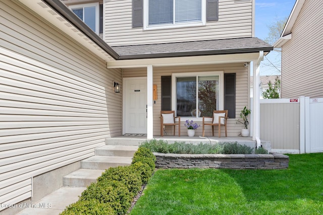 property entrance with fence and a porch