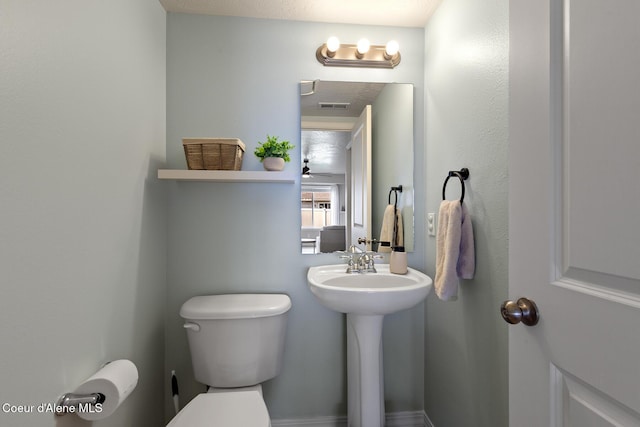 bathroom with visible vents and toilet