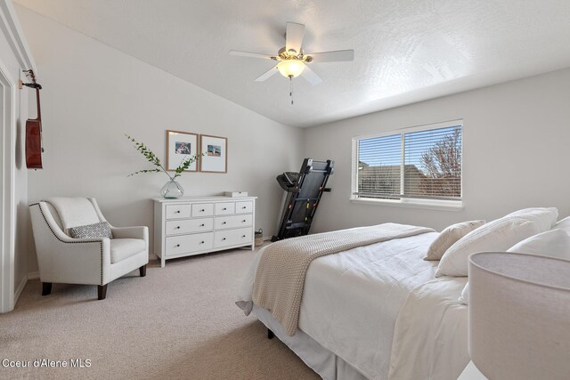bedroom with light colored carpet, ceiling fan, and vaulted ceiling