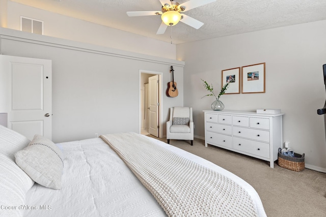 carpeted bedroom featuring a ceiling fan, visible vents, and baseboards
