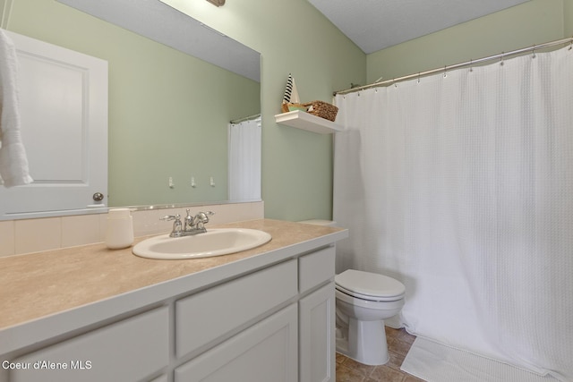 bathroom featuring curtained shower, vanity, toilet, and tile patterned flooring