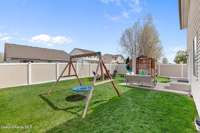 view of jungle gym featuring a lawn, an outdoor hangout area, a fenced backyard, and a patio area