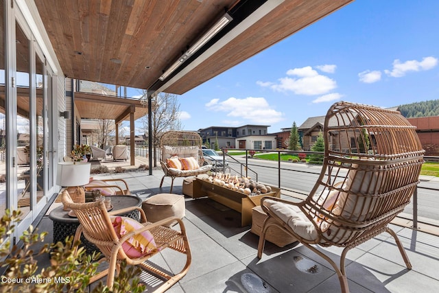 view of patio / terrace with an outdoor hangout area, a balcony, and a residential view