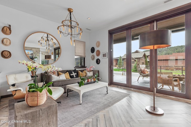 living area with visible vents and a chandelier