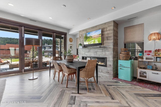 dining room with a fireplace and visible vents