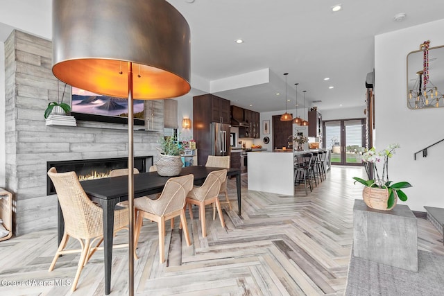 dining space with recessed lighting and a stone fireplace