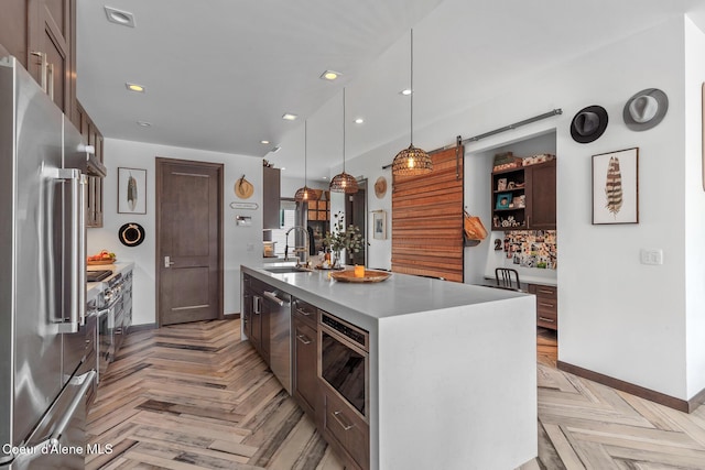 kitchen featuring a sink, open shelves, baseboards, light countertops, and appliances with stainless steel finishes