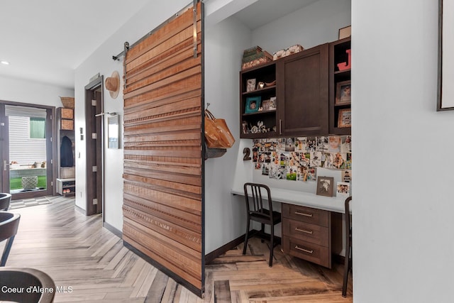 hall with a barn door and recessed lighting