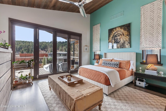 bedroom featuring access to exterior, visible vents, multiple windows, and wood ceiling