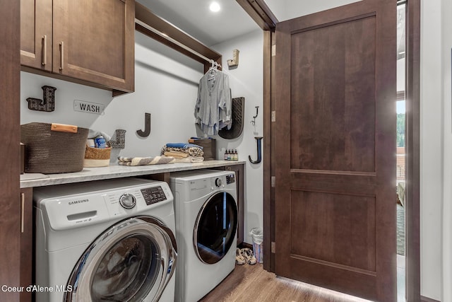 washroom with cabinet space, independent washer and dryer, and light wood-type flooring
