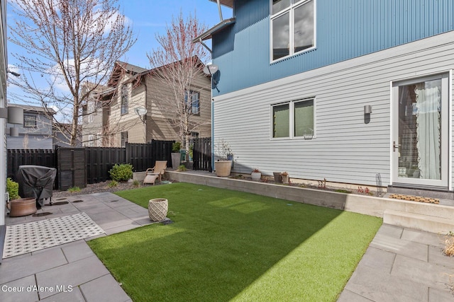 view of yard with fence and a patio