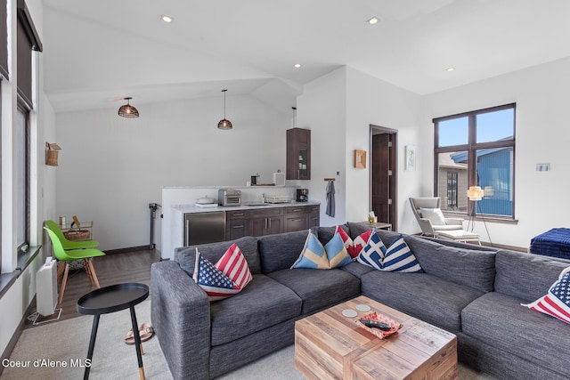 living area featuring a toaster, recessed lighting, light wood finished floors, and vaulted ceiling