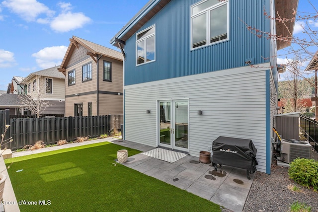 back of house featuring fence, a yard, a patio, and central AC