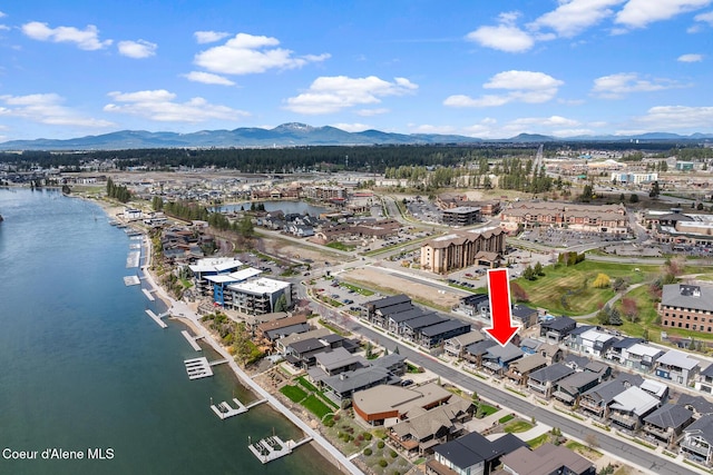 birds eye view of property with a water and mountain view