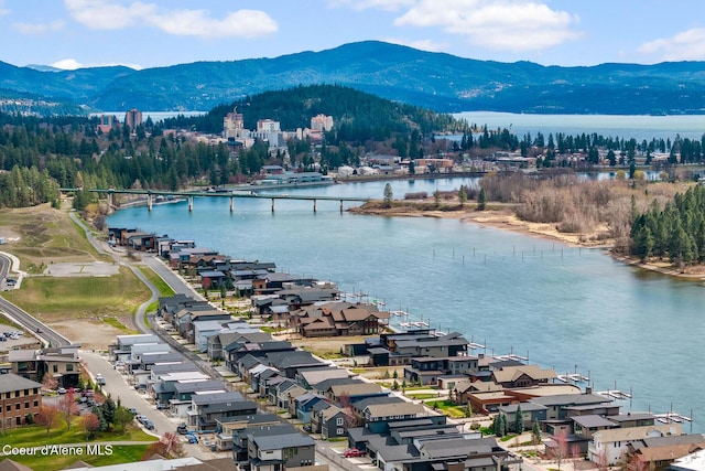 birds eye view of property with a water and mountain view