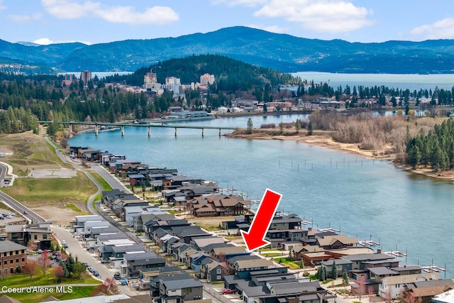 birds eye view of property featuring a water and mountain view