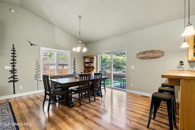 dining area with visible vents, a notable chandelier, wood finished floors, and a wealth of natural light