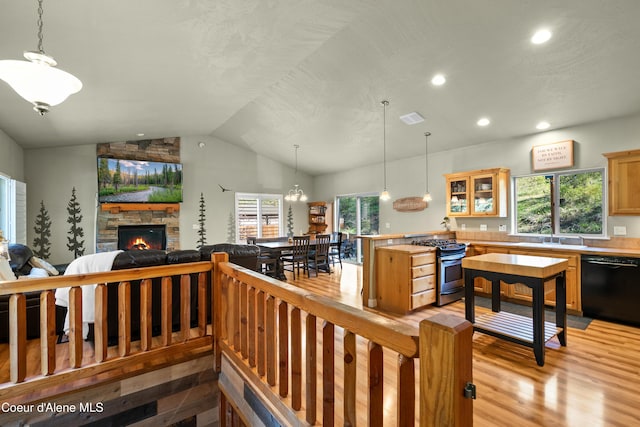 interior space featuring visible vents, a fireplace, lofted ceiling, recessed lighting, and light wood-style flooring