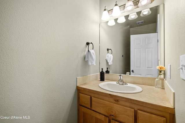 bathroom with visible vents and vanity
