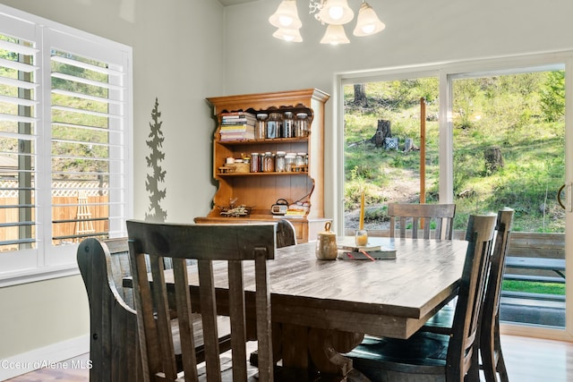 dining space with a wealth of natural light and a chandelier