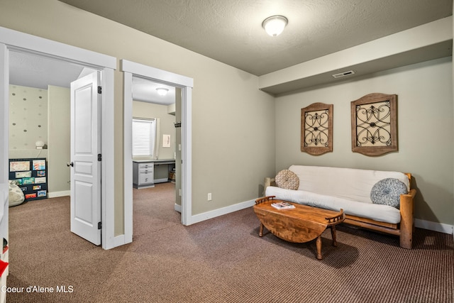 sitting room featuring baseboards, visible vents, and carpet