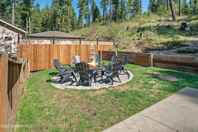view of yard featuring a fenced backyard, a patio, and a fire pit