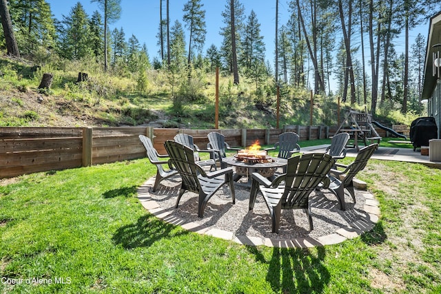 view of yard featuring fence and a fire pit