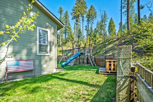 view of yard with a fenced backyard and a playground
