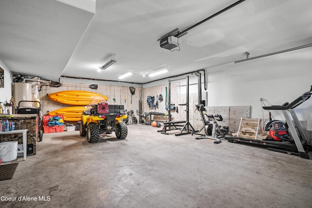 garage with a garage door opener and water heater