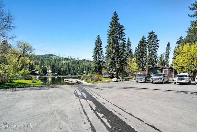 view of road with a view of trees and a water view