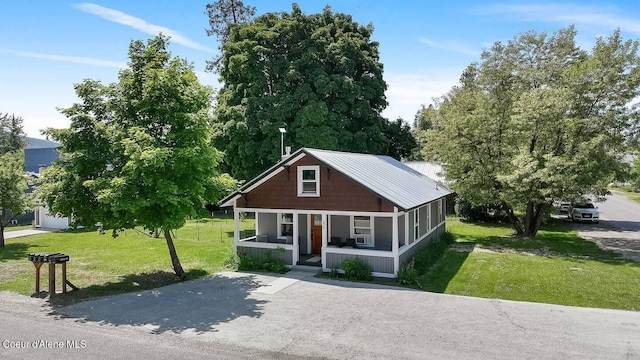 bungalow-style home featuring a porch and a front lawn
