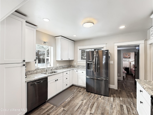 kitchen featuring a sink, stainless steel fridge, dishwasher, and a wealth of natural light