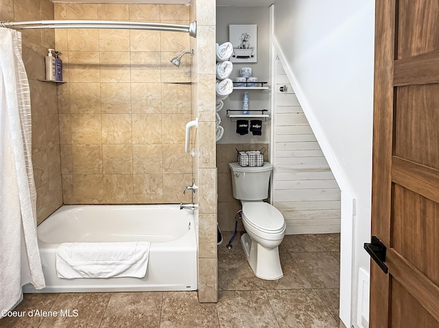 bathroom featuring tile patterned floors, shower / bath combination with curtain, and toilet
