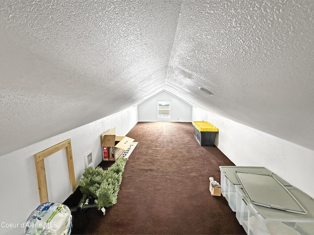 additional living space featuring a textured ceiling, carpet flooring, and lofted ceiling