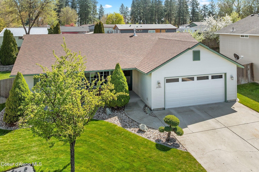2840 N Wickiup Dr, Post Falls, ID 83854 - view of front of property featuring concrete driveway, an attached garage, fence, and a front yard
