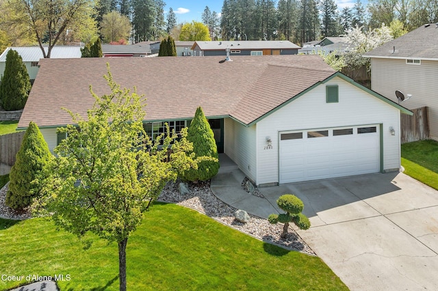 2840 N Wickiup Dr, Post Falls, ID 83854 - view of front of property featuring concrete driveway, an attached garage, fence, and a front yard